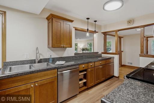 Functional kitchen design has plenty of cabinet spaces for storing dishes, pots and pans and silverware