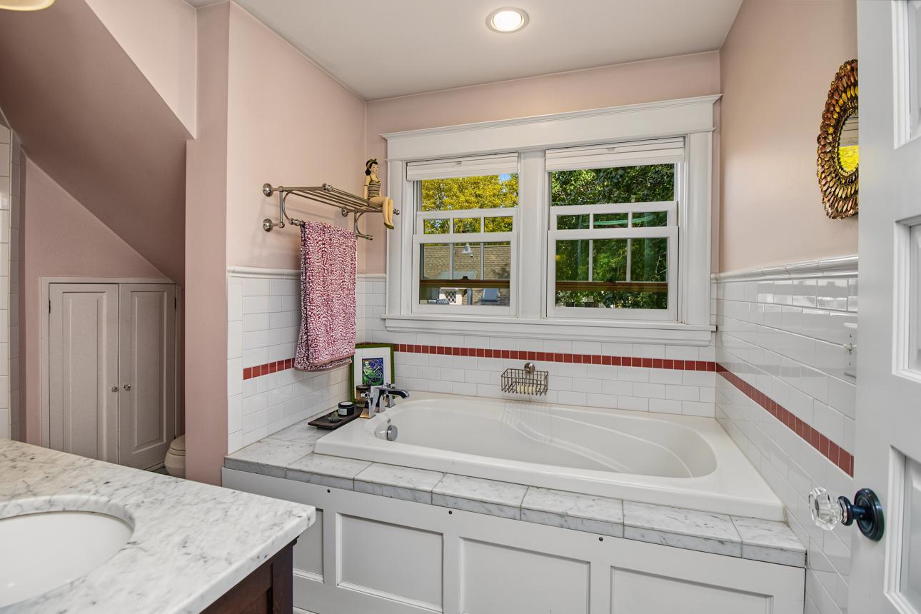 Primary bath room with tub and it's own hot water heater