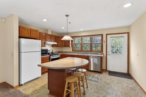 Spacious kitchen with lots of cabinetry and center island with seating.