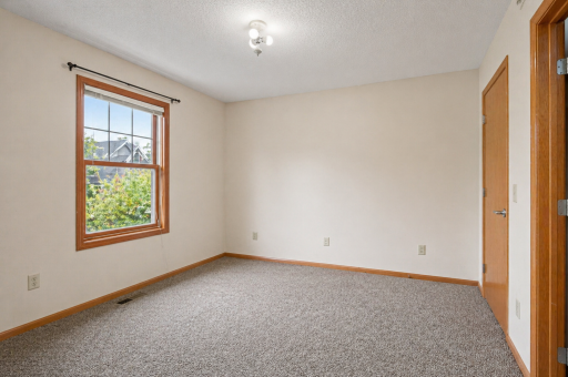 Primary bedroom with a walk-in closet and walk-through access to the full bathroom and laundry room.