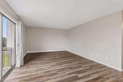 Earth-tones luxury vinyl plank flooring throughout common areas.