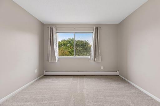 Guest bedroom features large west-facing windows.