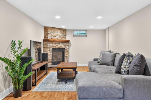 The basement was fully finished with fresh flooring, trim, paint, and a cozy gas fireplace!