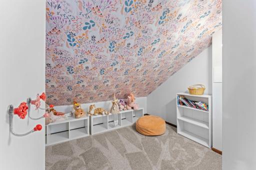 Upper level bedroom features a closet and adorable reading/play nook