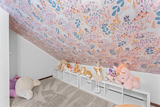 Upper level bedroom features a closet and adorable reading/play nook