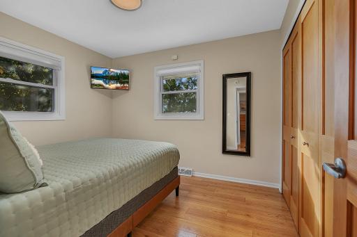 First bedroom on the main level. Queen bed, Solid core paneled doors, new lighting and custom closet organizers. Views of the lake!