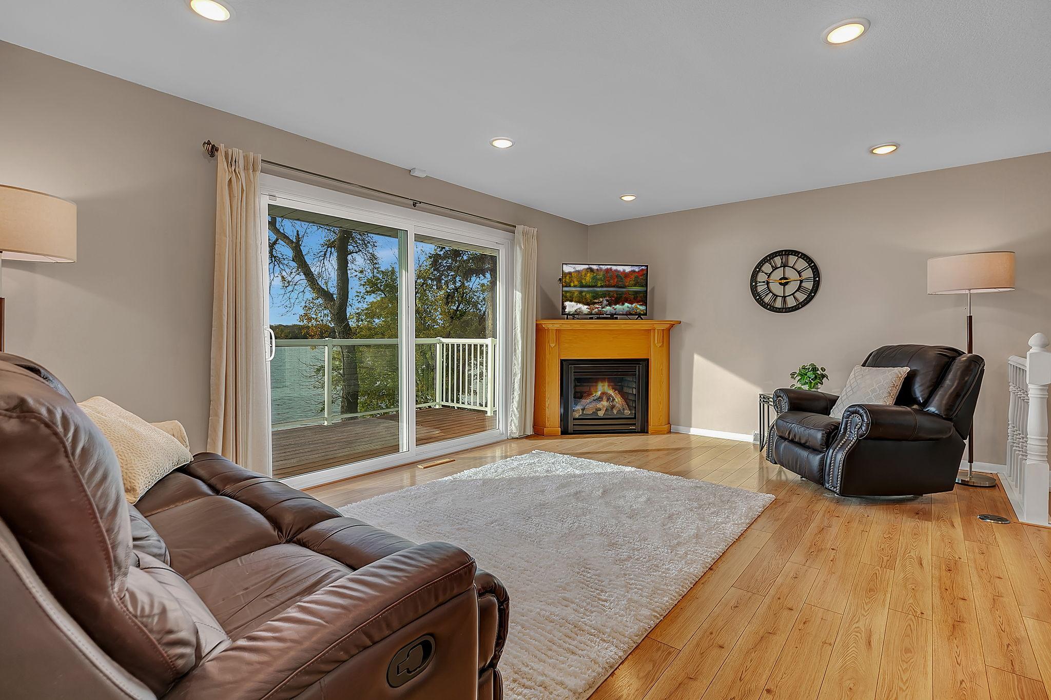 Open layout, gas fireplace and oversized sliding patio door for easy access to the maintenance free deck