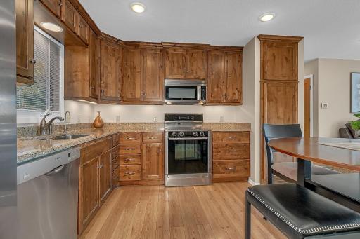 Knotty alder custom cabinets, stainless steel appliances and quartz countertops - move-in ready!