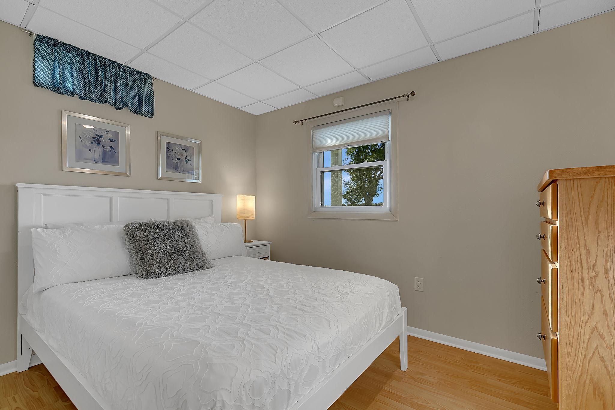 Lower level bedroom with built-in dresser and lake views