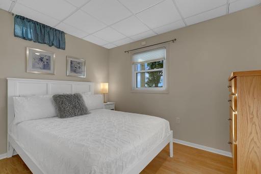 Lower level bedroom with built-in dresser and lake views