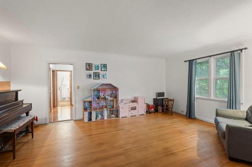 A formal dining space offering hardwood floors, side yard views and two storage closets.