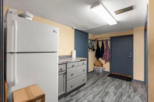 The lower level offers access to the attached two-car garage through a convenient mudroom, complete with a spacious storage room, closets, and built-in cabinetry.