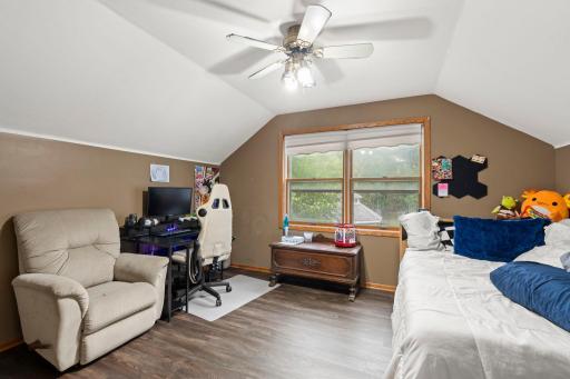 The fourth bedroom is located on the upper level, overlooking the backyard.