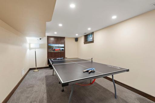 The lower-level recreation room offers flexible space for an additional family room, game room, or gathering area.
