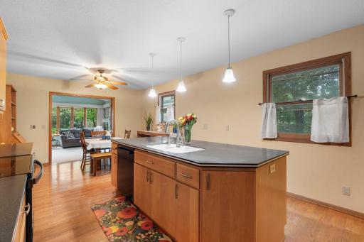 Large center island with pendant lighting, offering plenty of storage and generous counter space, ideal for everyday living or entertaining.