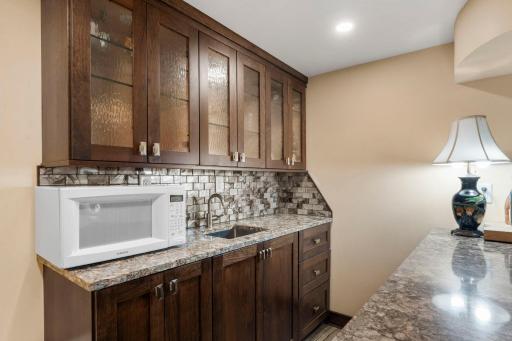 The wet bar could also serve as a convenient potential kitchenette, adding flexibility to the lower level.