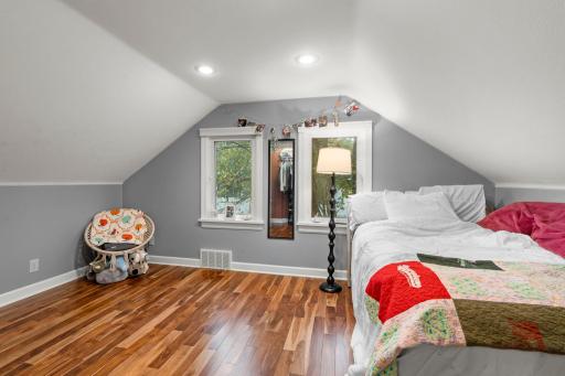 The third bedroom is located on the upper level, overlooking the side yard and featuring beautiful hardwood floors.