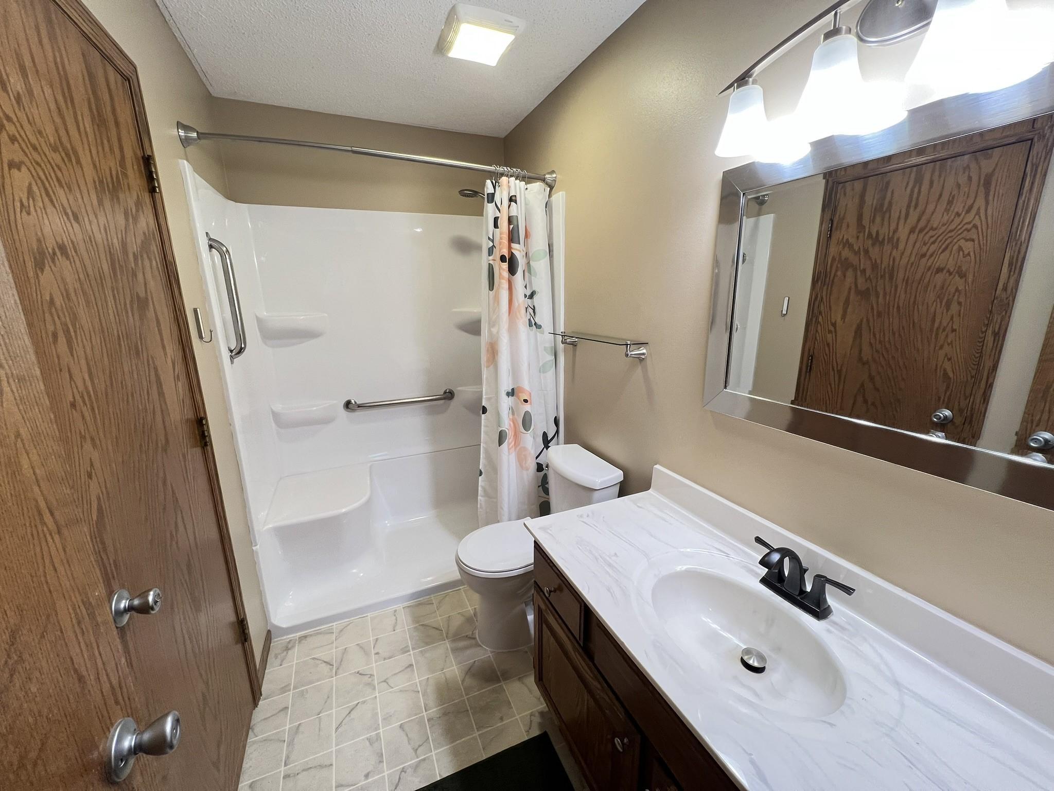 Main floor bath with newer walk-in shower installed.