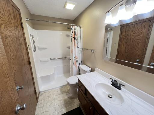 Main floor bath with newer walk-in shower installed.