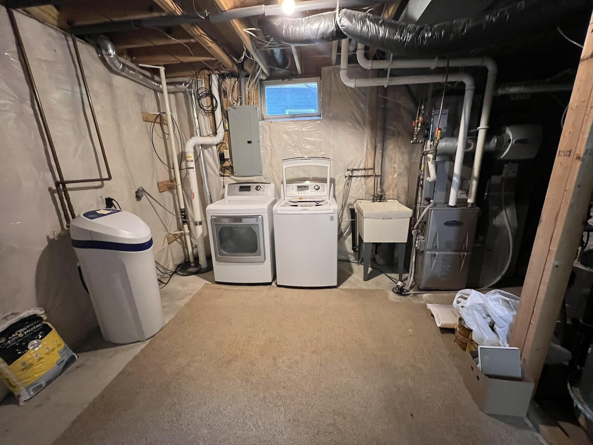 Mechanical room with newer furnace and central air.