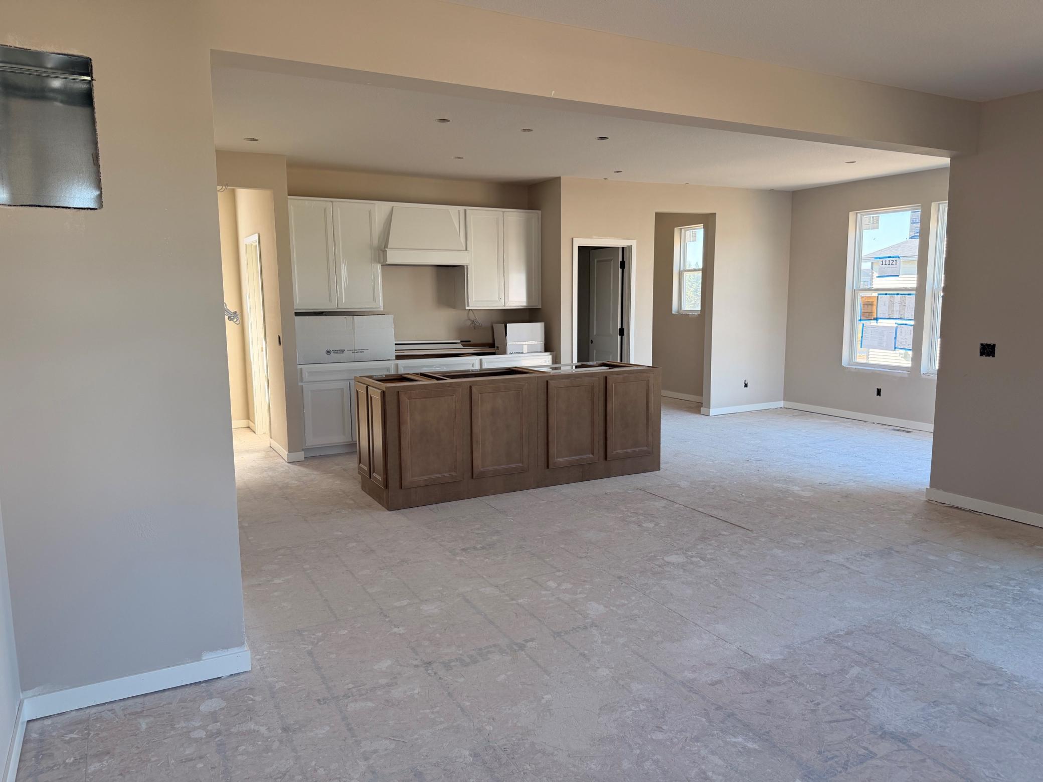 Central island offers additional prep space, seating, and storage, making it the heart of the home.