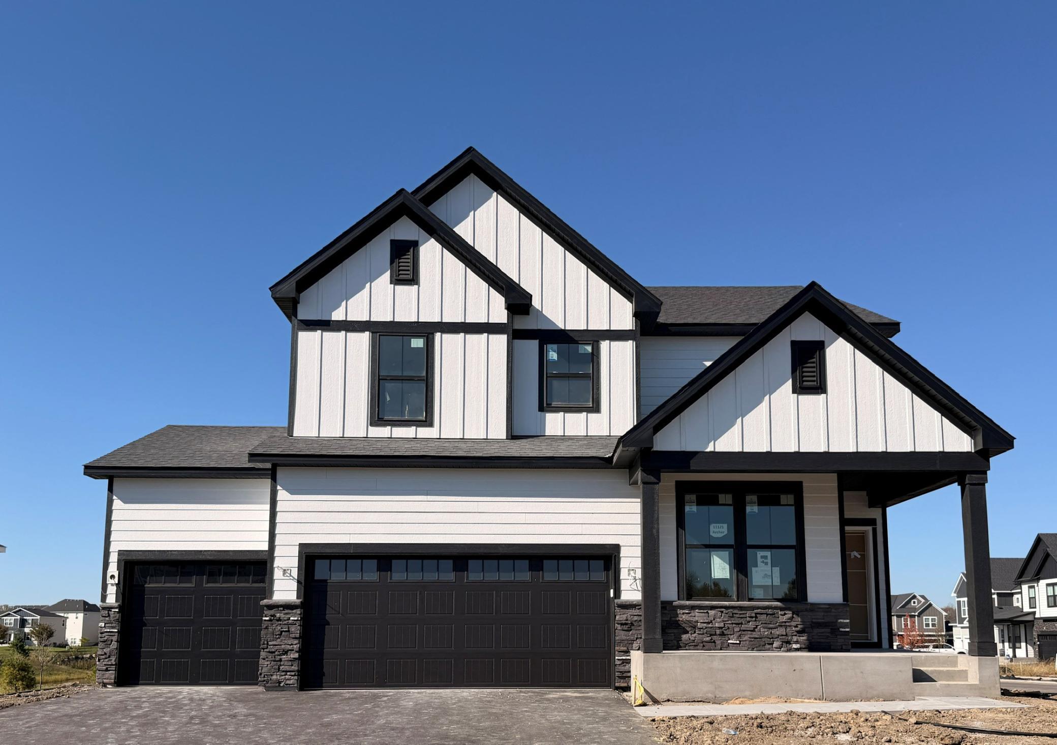 High-quality modern materials, including vinyl siding, stone accents, and contrasting trims combine to create a sophisticated and durable exterior