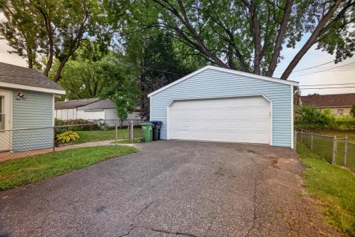 Large 2 car garage with space for storage on either side.