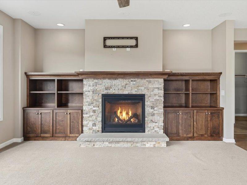 Main level family room with gas fireplace, beautiful built ins, plus Tv mount above