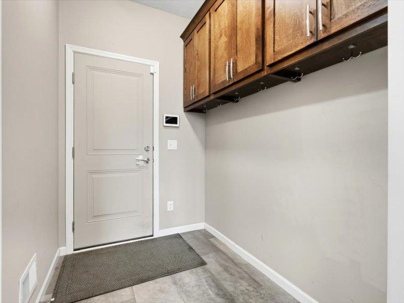 Back entry from the oversize triple garage. Built ins above