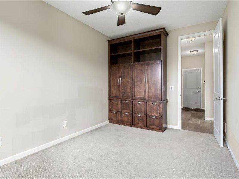 The other end of this flex room has beautiful built in cabinetry