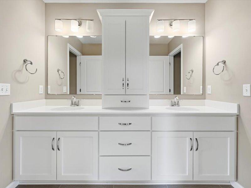 Large vanity with two separated sinks and lots of storage in the jack and jill bath