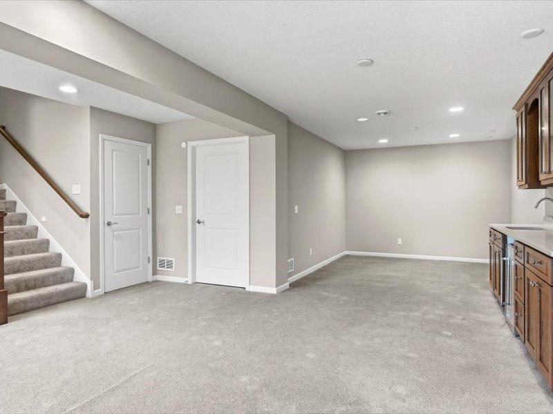 Lower level is all finished. Also note that the utility room has the furnace and mechanicals, plus an extra storage room to the back of this area. also, lights are on a motion detector....step in 2 steps and the lights go on