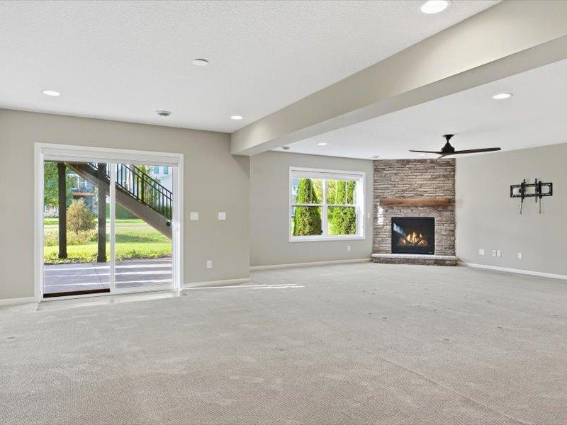 Showing the walkout to the very large patio, plus view across lower level family room