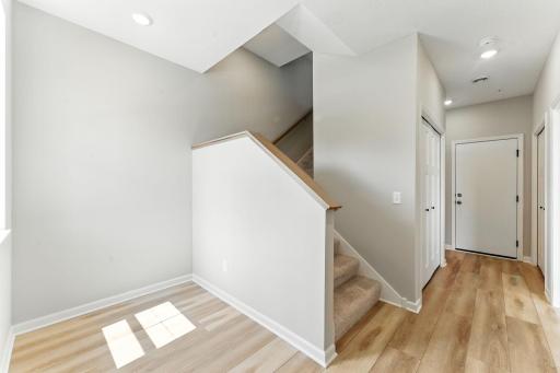 Entry at garage level to main level. Photo of previous model home, options and color selections may vary.
