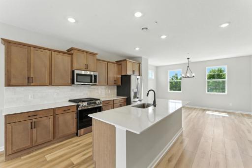 Huge quartz island. Photo of previous model home, options and color selections may vary.