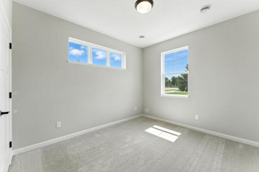 Owners Suite with Natural Light from being and End Unit. Photo of previous model home, options and color selections may vary.