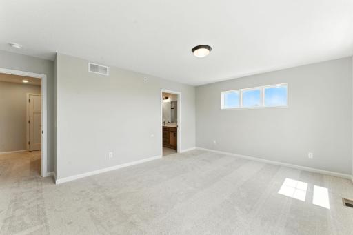 Owners Suite with Private Bath and Walk-in Closet. Photo of previous model home, options and color selections may vary.