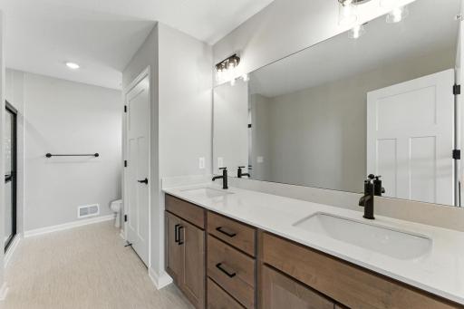 Private Owners Bath with large Vanity and Standing Shower with Glass enclosure. Photo of previous model home, options and color selections may vary.
