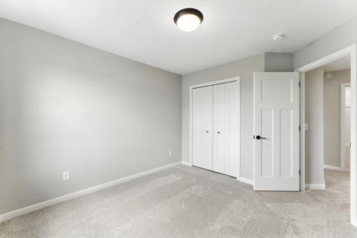 Another view of Bedroom 1. Photo of previous model home, options and color selections may vary.
