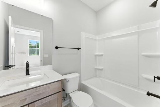 Hall Bath Shared with Easy Clean Tub/Shower. Photo of previous model home, options and color selections may vary.