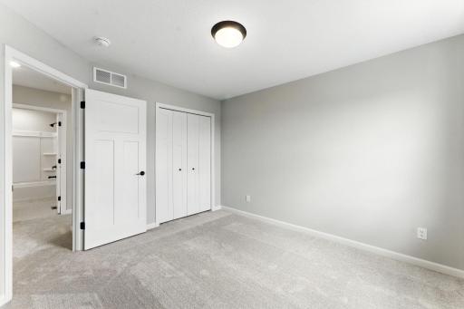 Another view of Bedroom 2. Photo of previous model home, options and color selections may vary.