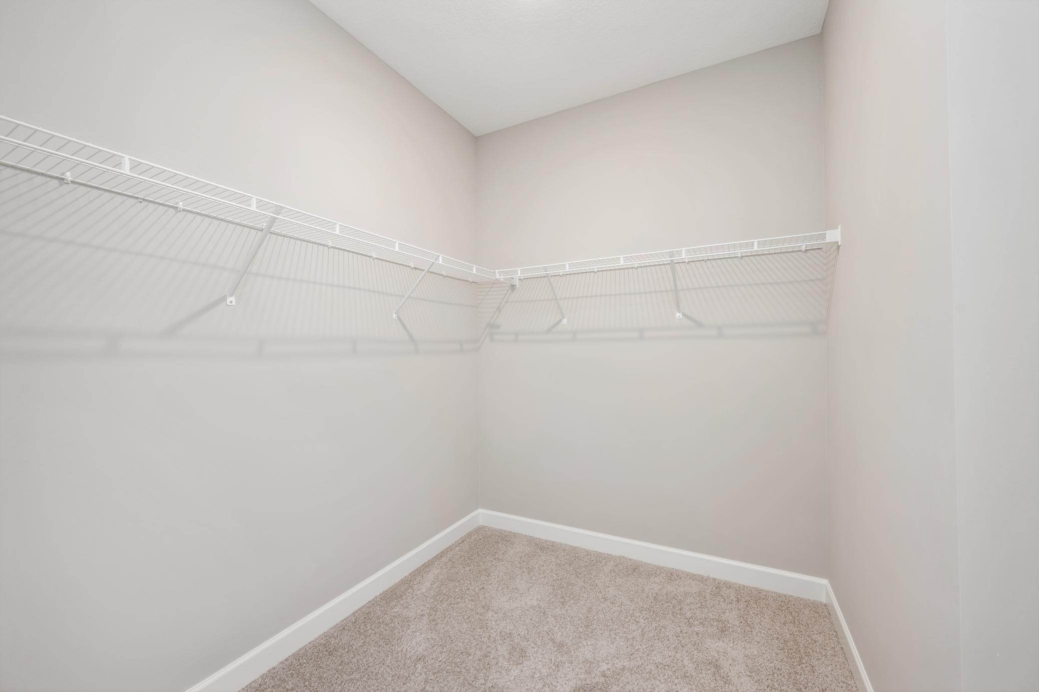 Primary suite walk-in closet - photos are of a completed inventory home of the same floorplan. Colors and selections may differ.