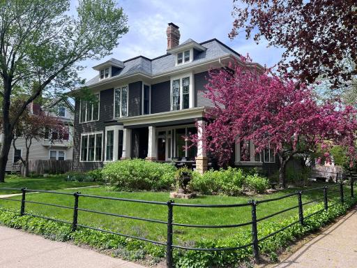 View of home from corner of Portland and Mackubin. Note decrotive "Faux Bois" metal fencing