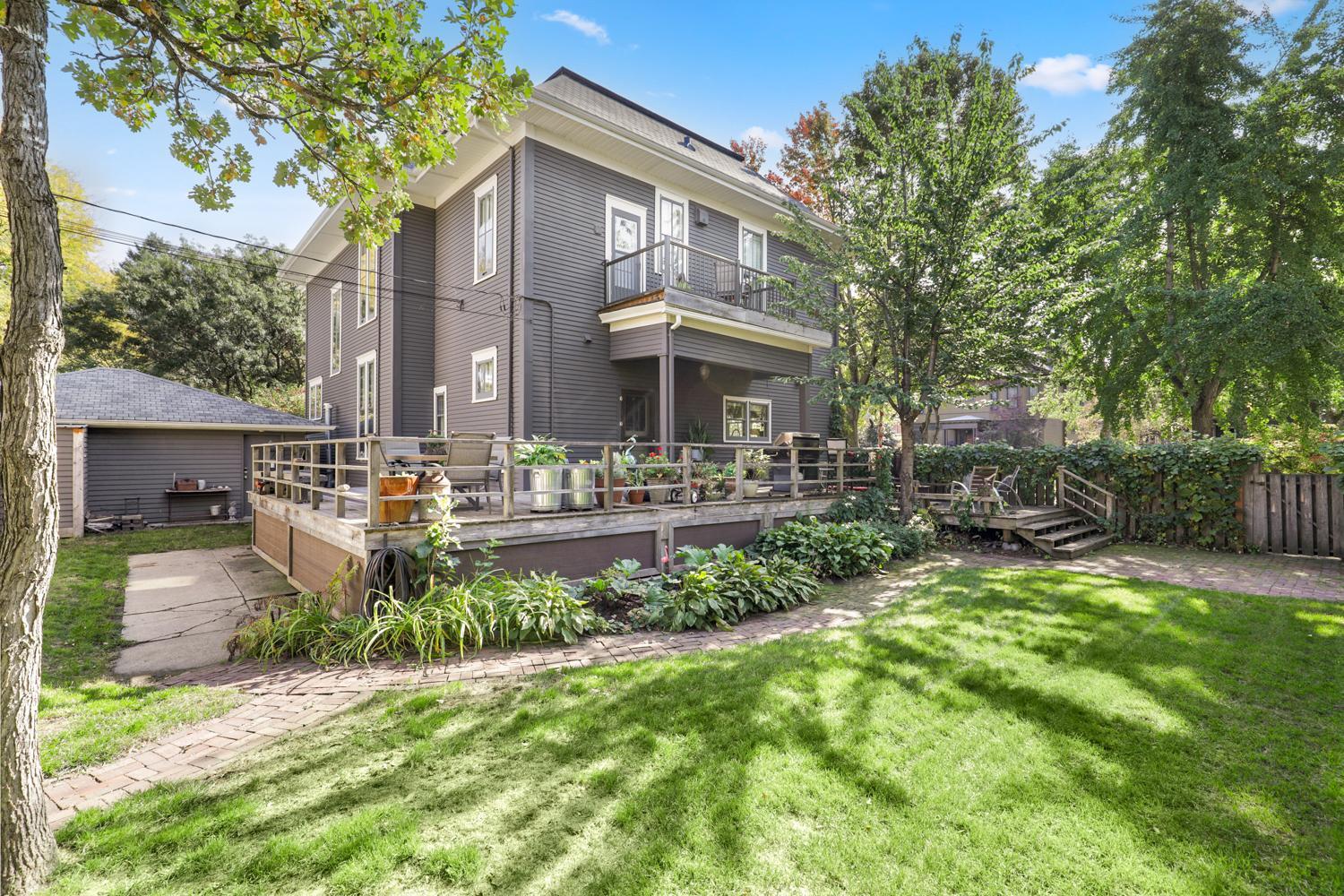 Side Yard of home with view of upper deck and side entrance.