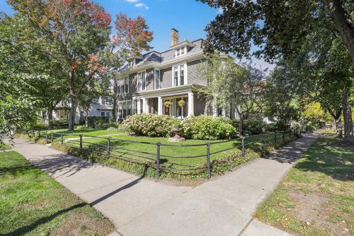 View of home from corner of Portland and Mackubin. Note decrotive "Faux Bois" metal fencing