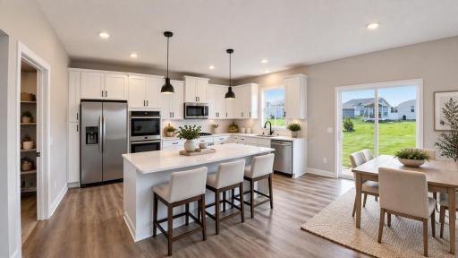 A stunning kitchen with ample counter space, double ovens, and a 7-foot island provides the perfect setting for entertaining guests. Photo of model home, other finishes will vary.