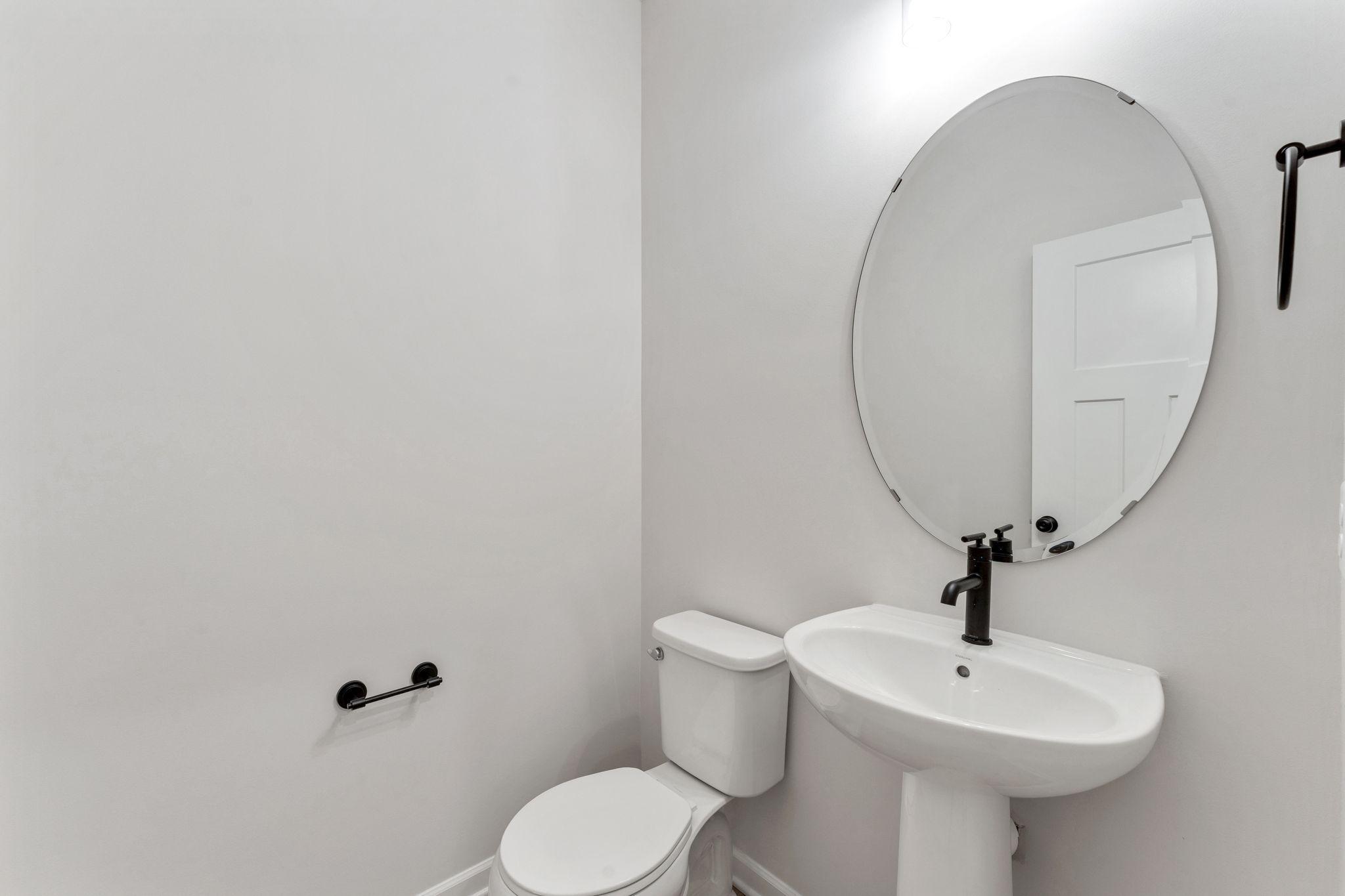 Convenient half bath with clean, modern finishes. Photo is for representational purposes only, not the actual home.