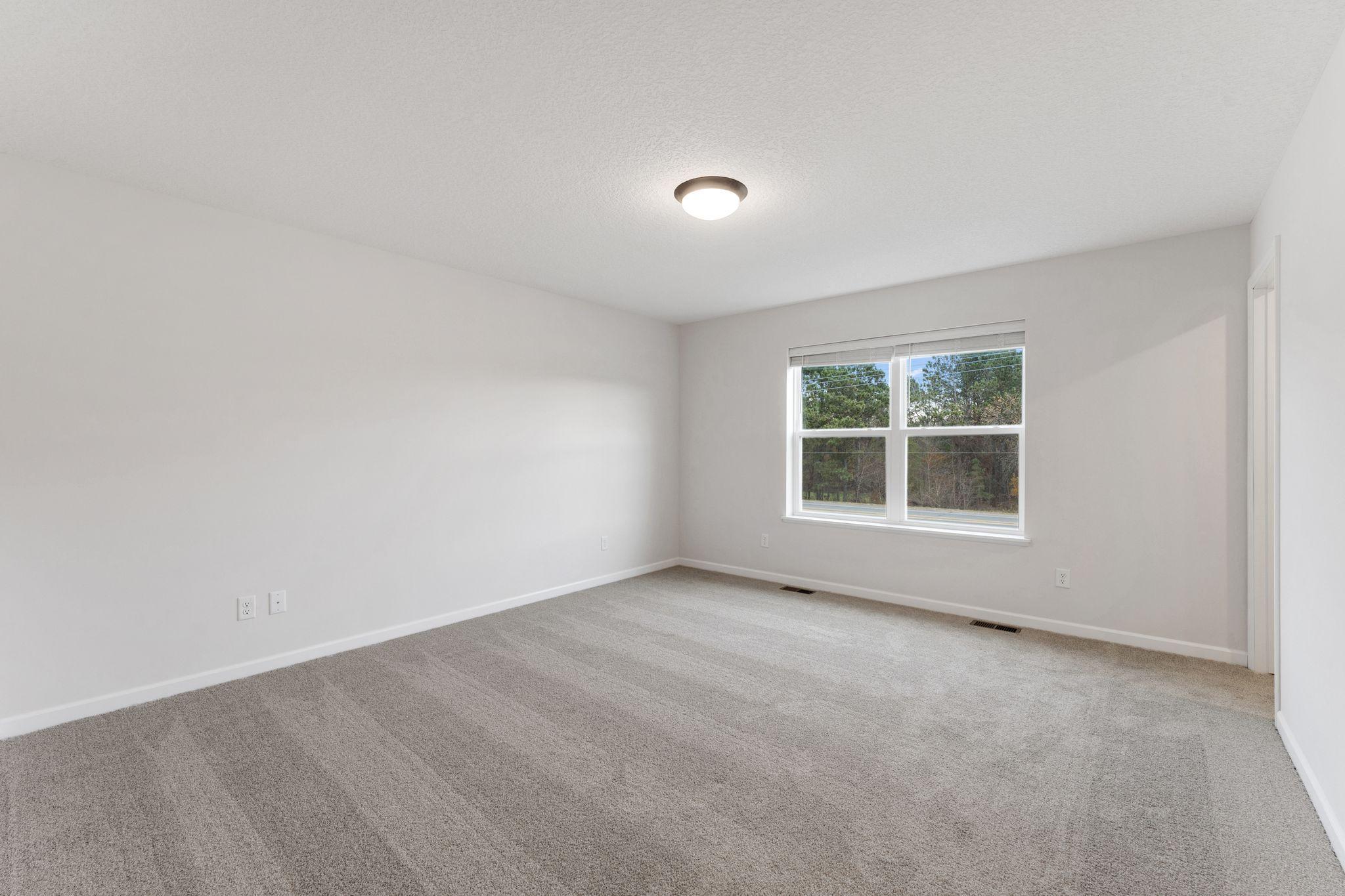 Spacious owner's suite offering a comfortable private retreat. Photo is for representational purposes only, not the actual home.
