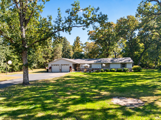 Beautiful rambler surrounded by mature shade trees, expansive lawn, and a peaceful, park-like setting.