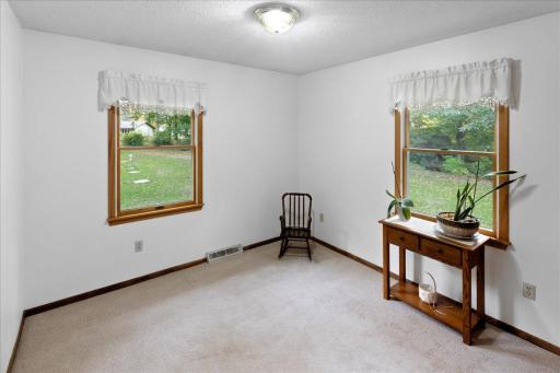 Versatile third main-level bedroom featuring two windows overlooking the beautiful yard. This room offers excellent potential for conversion into a main-level laundry room, providing the convenience of one-level living!